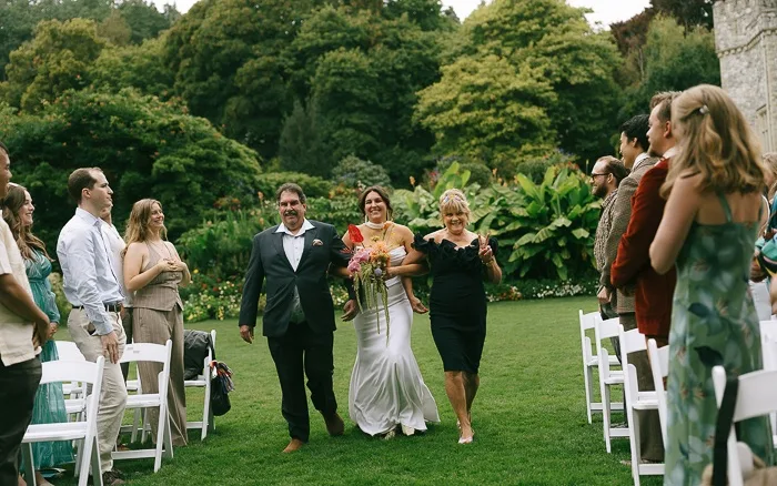 Bride walking down aisle with parents