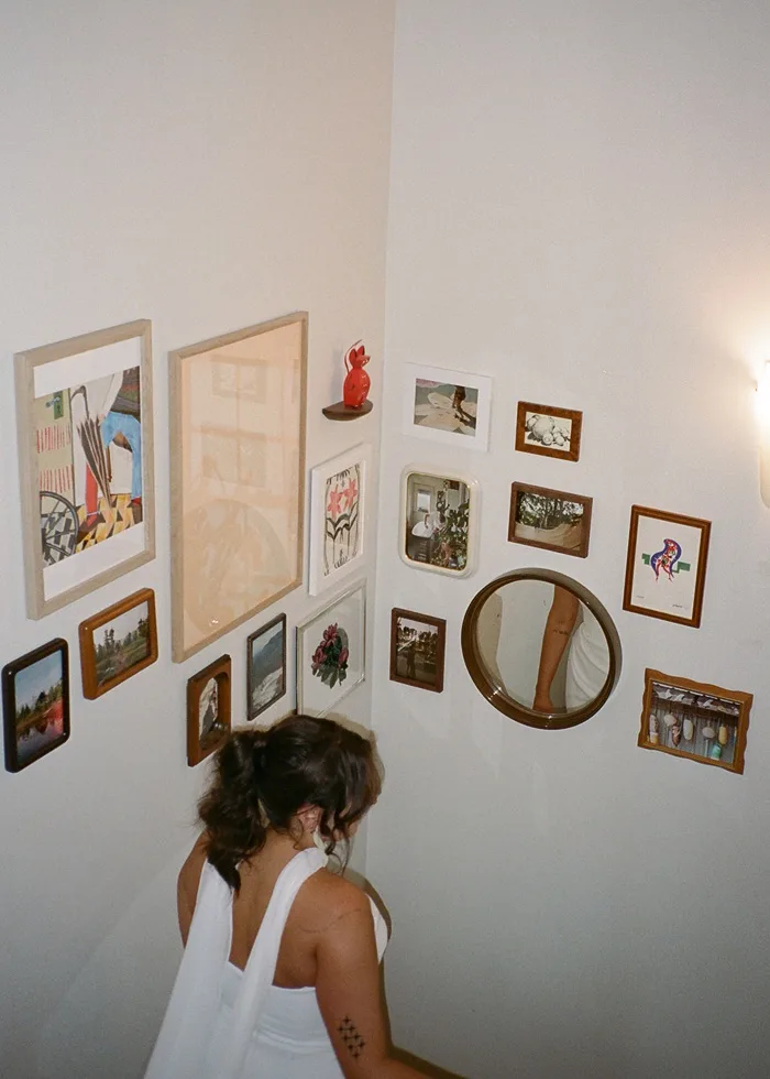 Bride on stairs past art wall